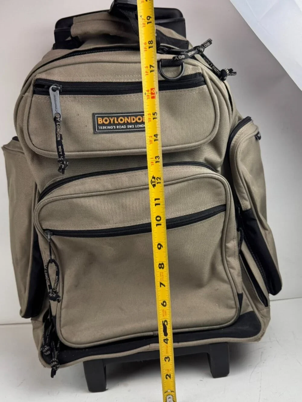 boy london rolling backpack tan wheeled suitcase travel bag tear fraying flaw